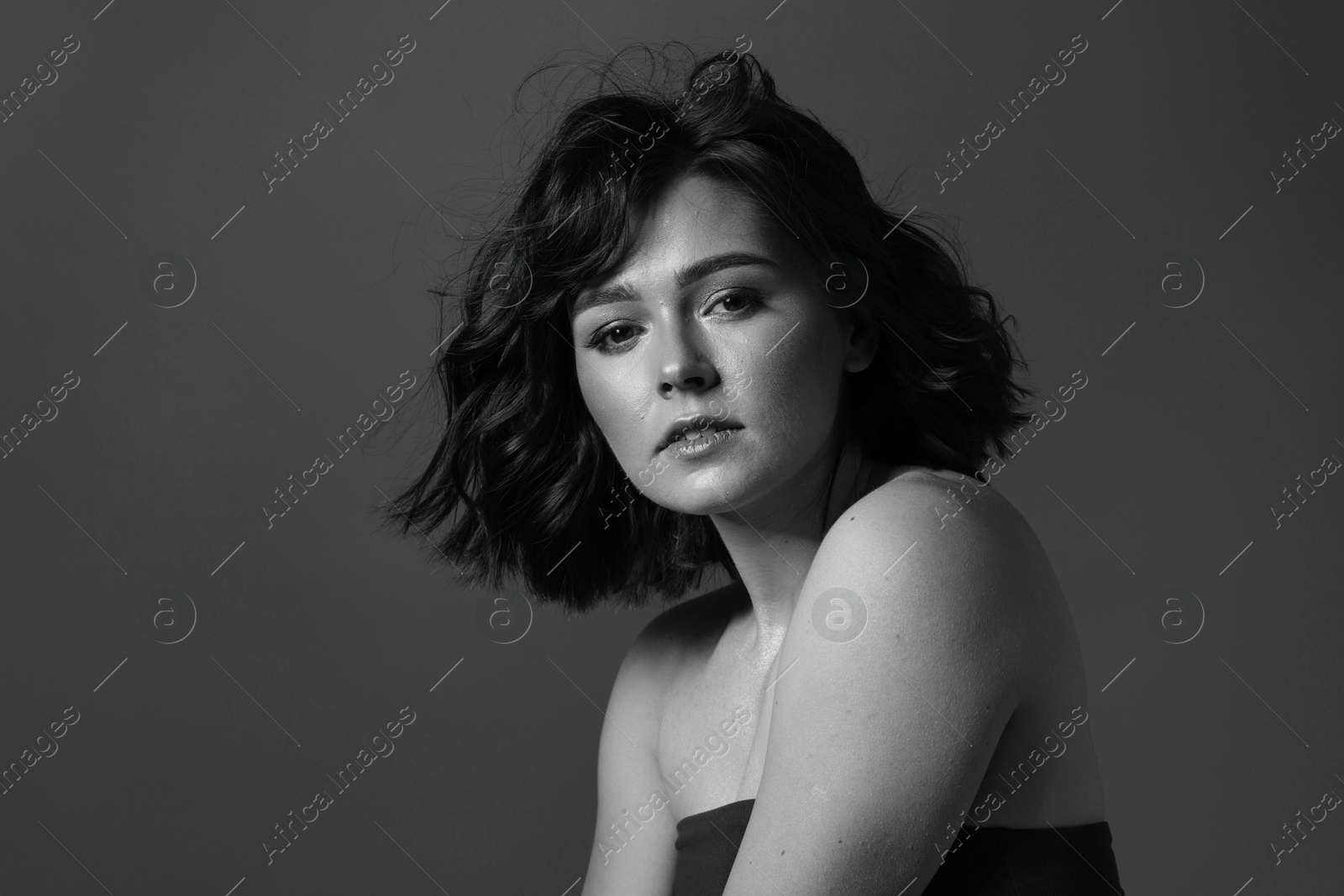Image of Attractive woman on grey background. Fashionable black and white portrait