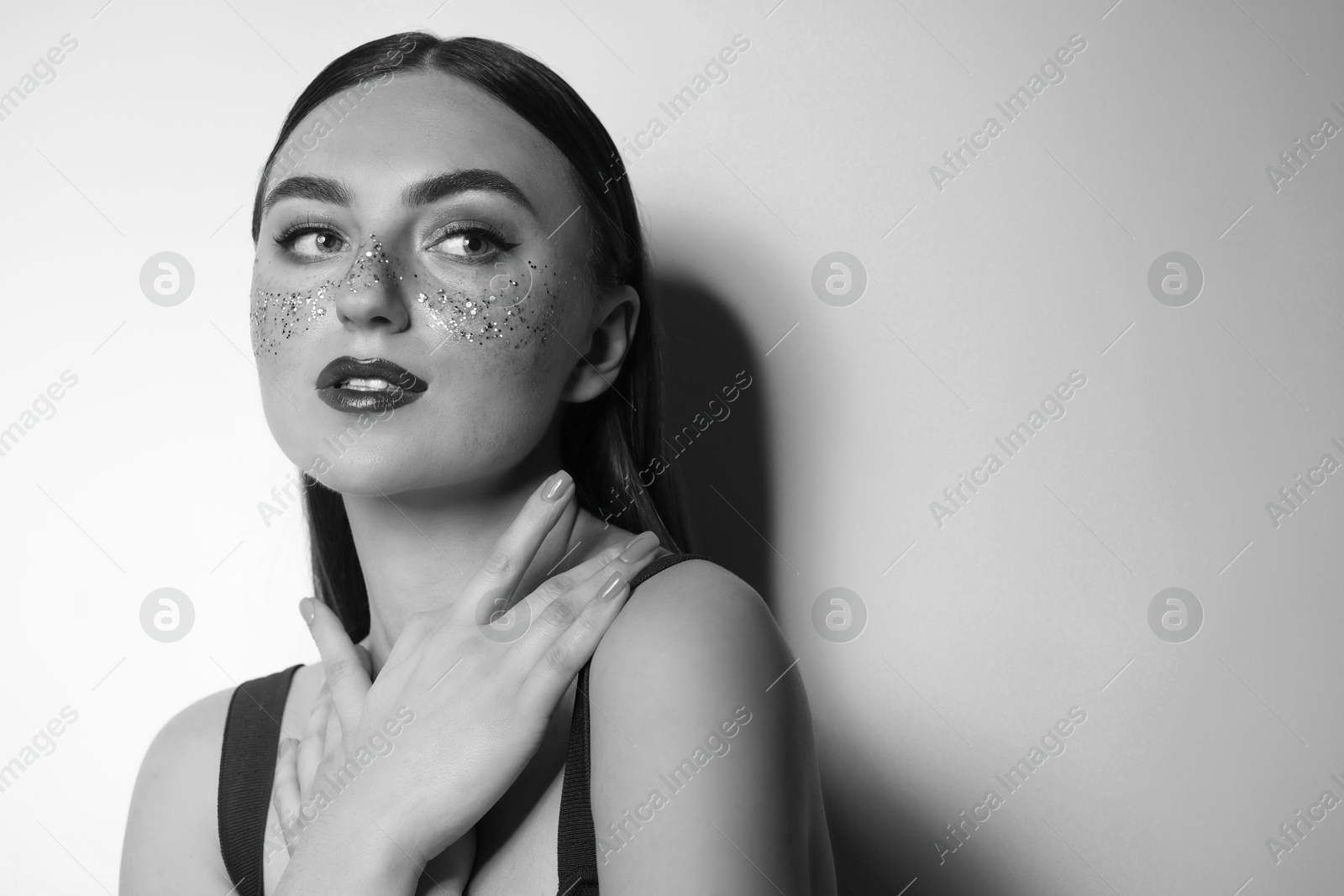 Image of Fashionable portrait of beautiful woman on light grey background, black and white effect