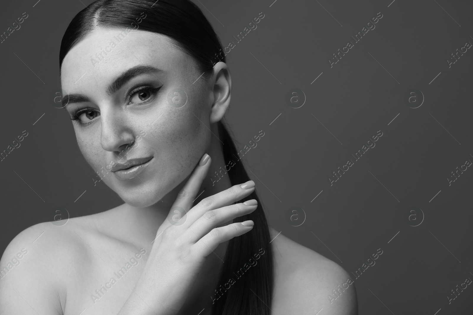 Image of Attractive woman on grey background. Fashionable black and white portrait