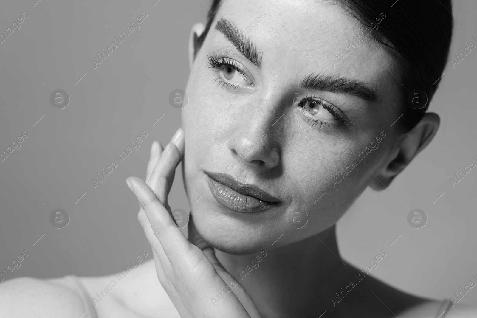 Image of Attractive woman on grey background. Fashionable black and white portrait