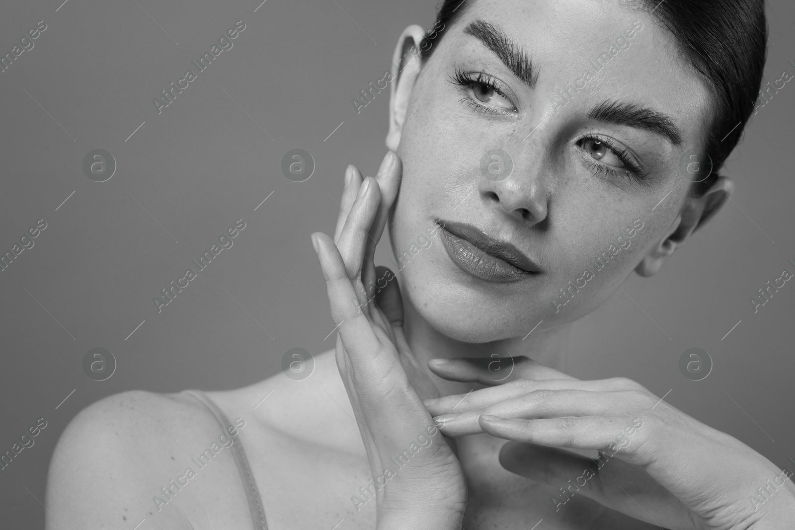 Image of Attractive woman on grey background. Fashionable black and white portrait