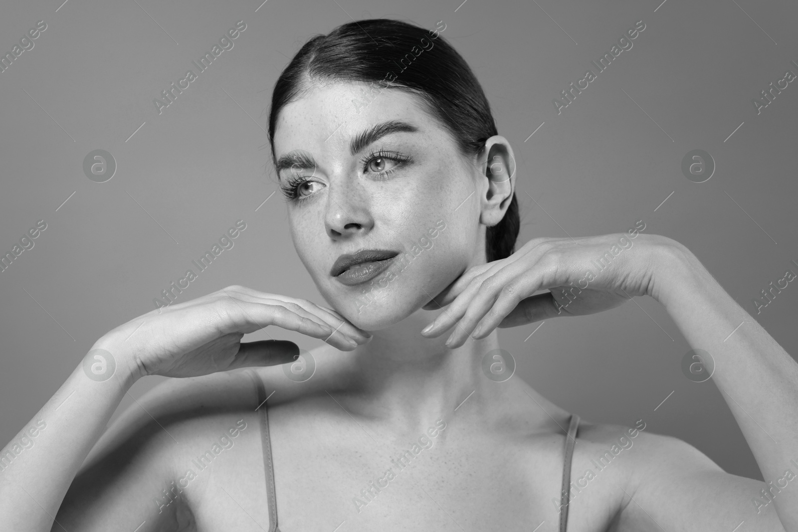 Image of Attractive woman on grey background. Fashionable black and white portrait