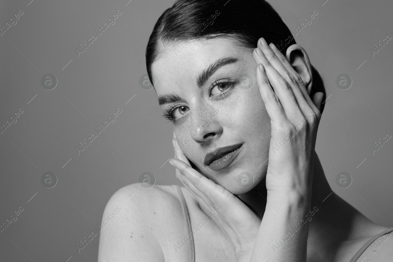 Image of Attractive woman on grey background. Fashionable black and white portrait