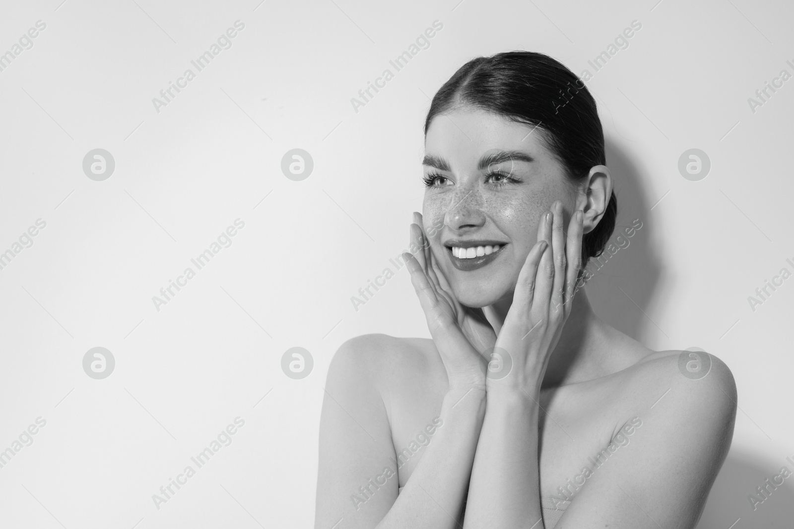 Image of Fashionable portrait of beautiful woman on light grey background, black and white effect