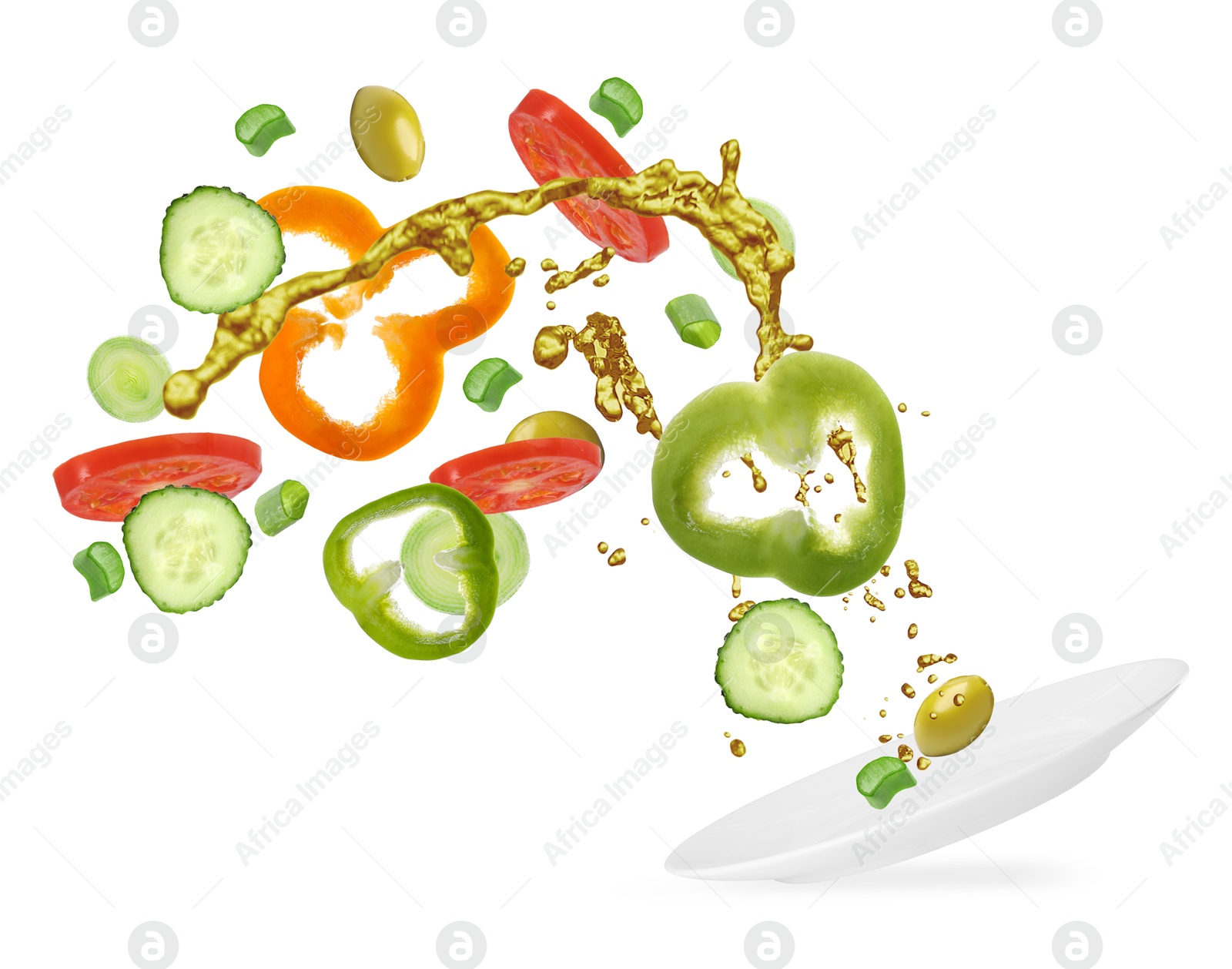 Image of Plate with fresh vegetables and oil in air on white background. Making fresh salad