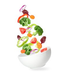 Image of Bowl with fresh vegetables in air on white background. Making fresh salad