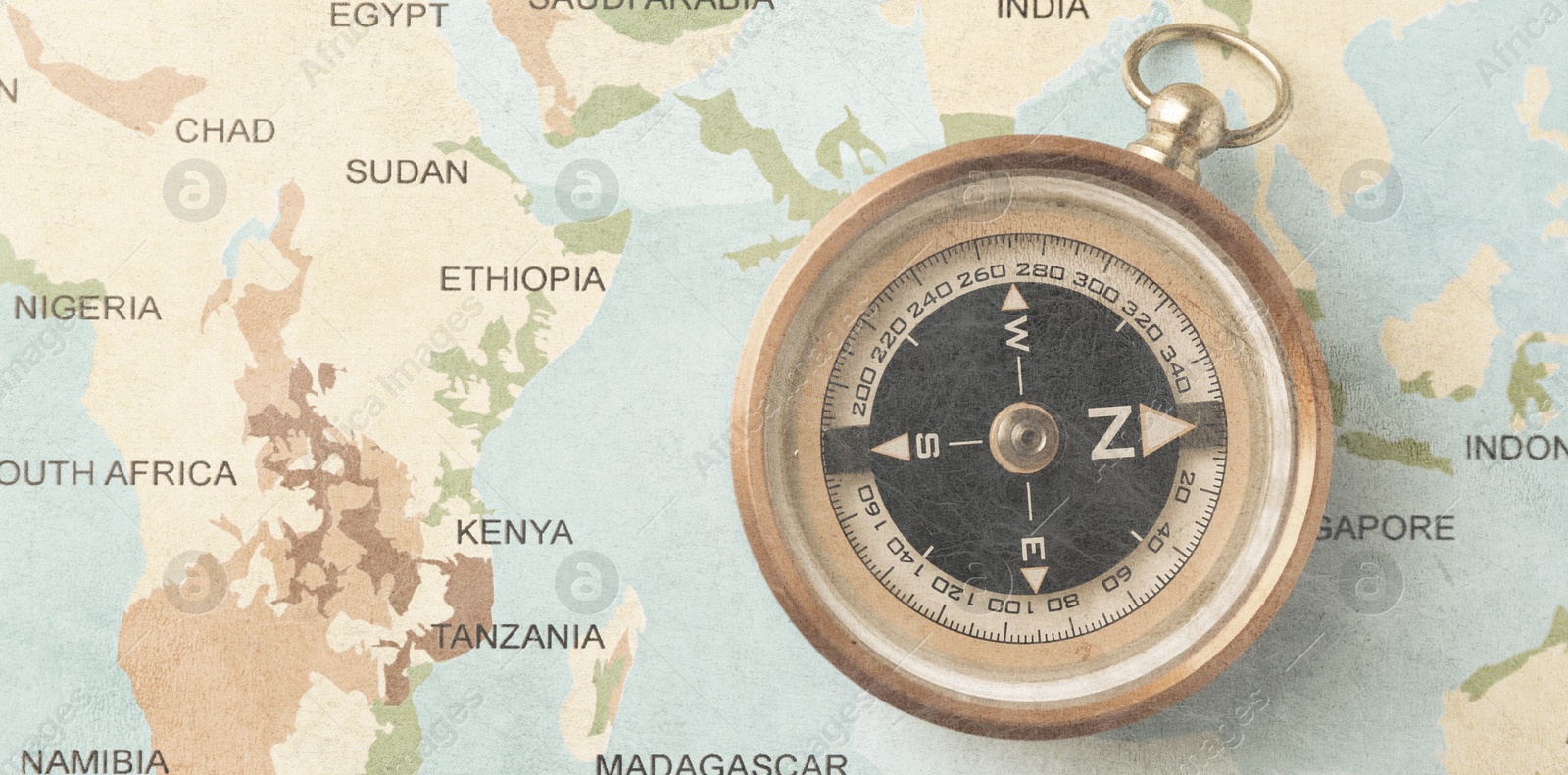 Image of Compass on world map, top view. Banner design with space for text