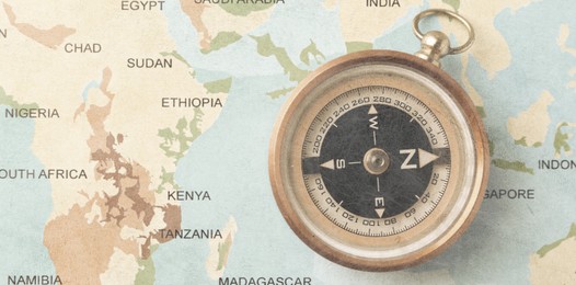 Image of Compass on world map, top view. Banner design with space for text