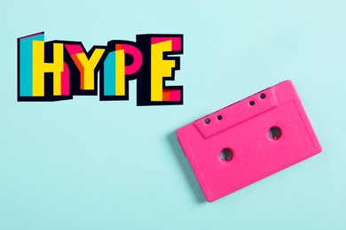 Illustration of Hype word of bright letters and pink audio cassette on cyan background, top view