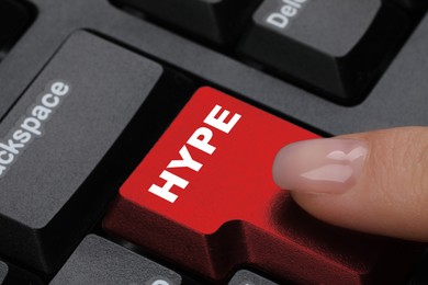 Woman pressing Hype button on computer keyboard, closeup