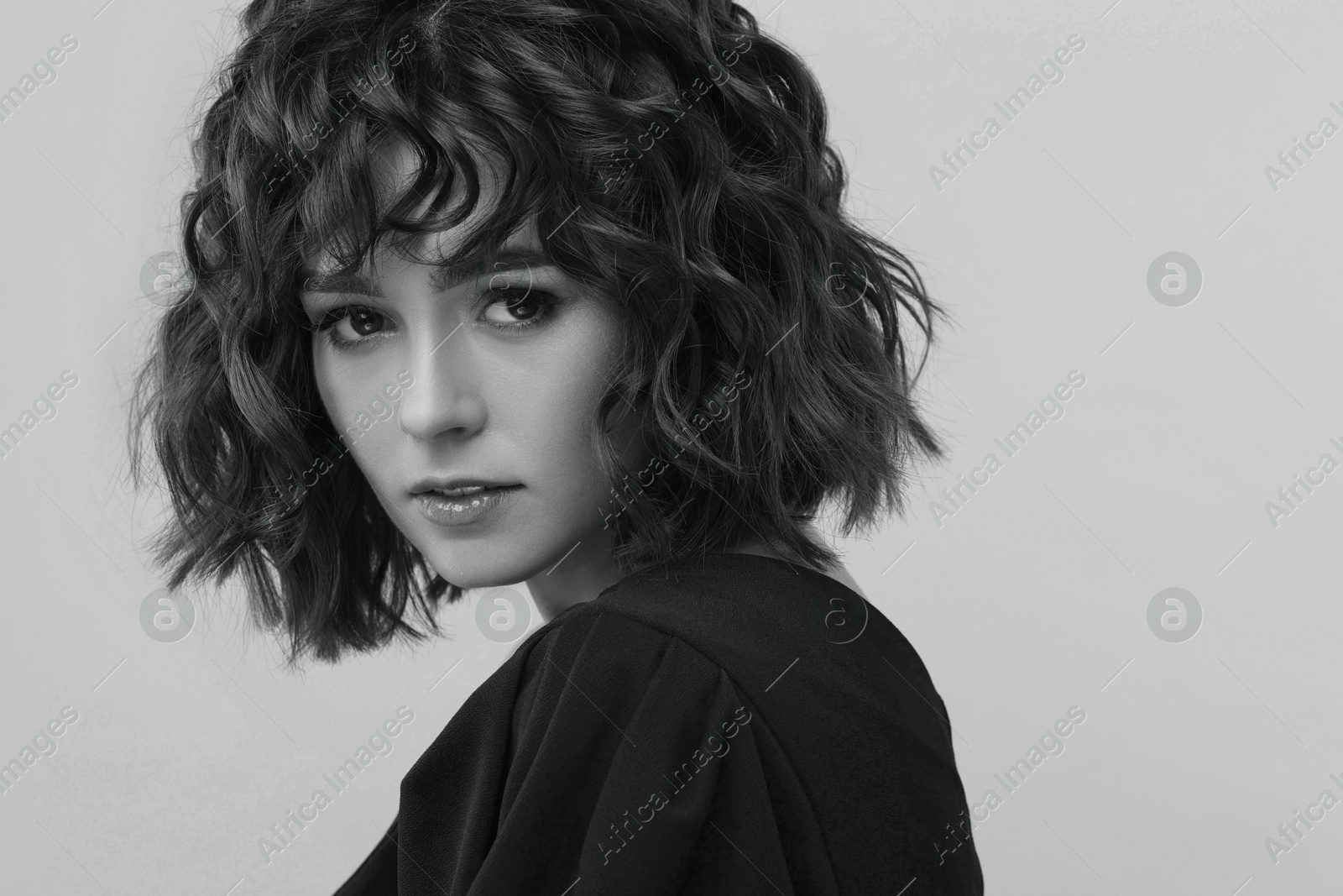 Image of Fashionable portrait of beautiful woman on light grey background, black and white effect