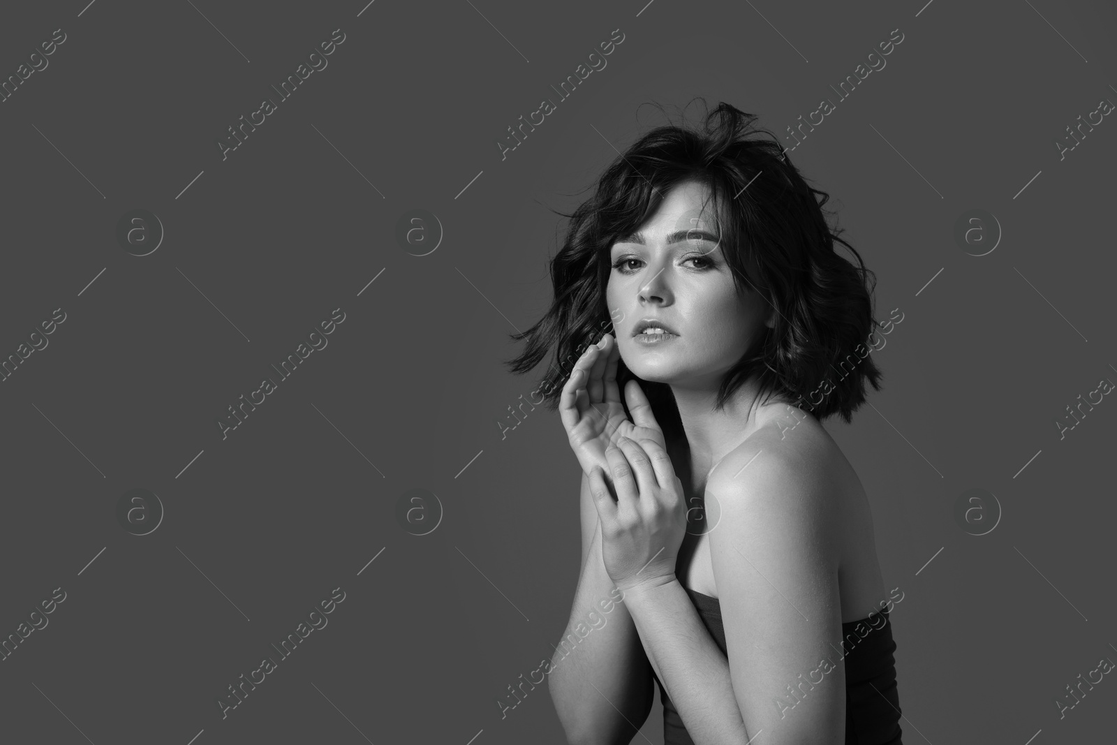 Image of Attractive woman on grey background. Fashionable black and white portrait