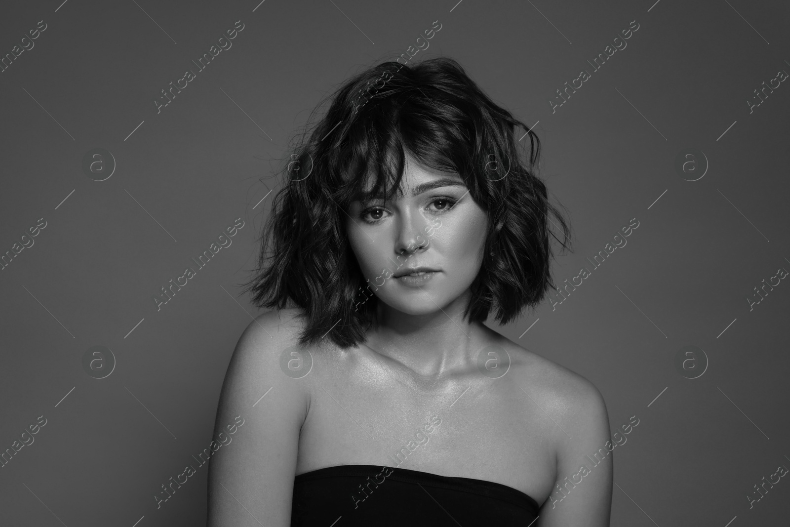 Image of Attractive woman on grey background. Fashionable black and white portrait