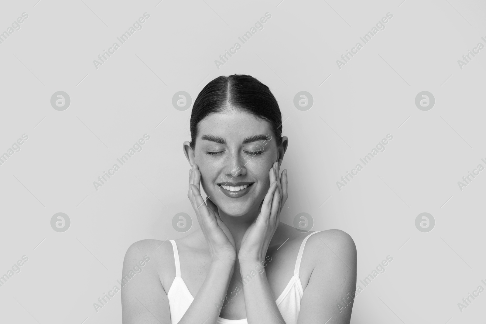 Image of Fashionable portrait of beautiful woman on light grey background, black and white effect