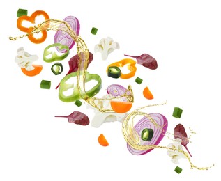 Fresh vegetables and oil for salad in air on white background