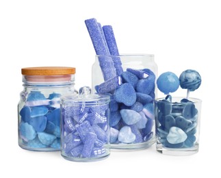 Many blue color candies in glass jars on white background