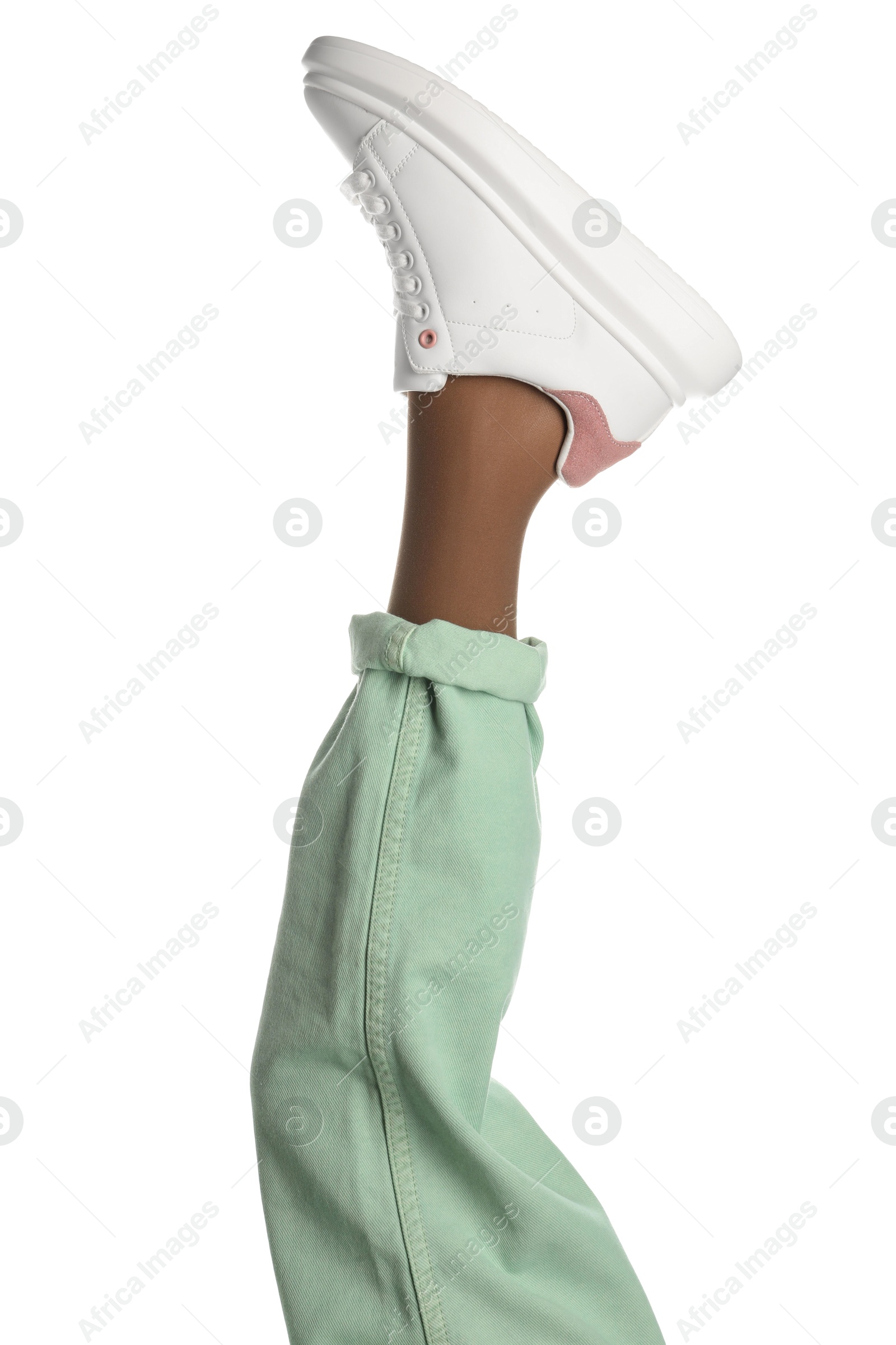 Photo of Woman wearing sneakers on white background, closeup