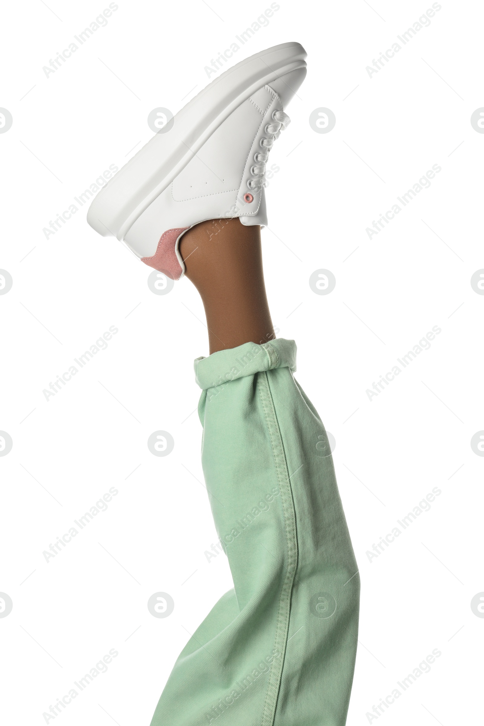 Photo of Woman wearing sneakers on white background, closeup