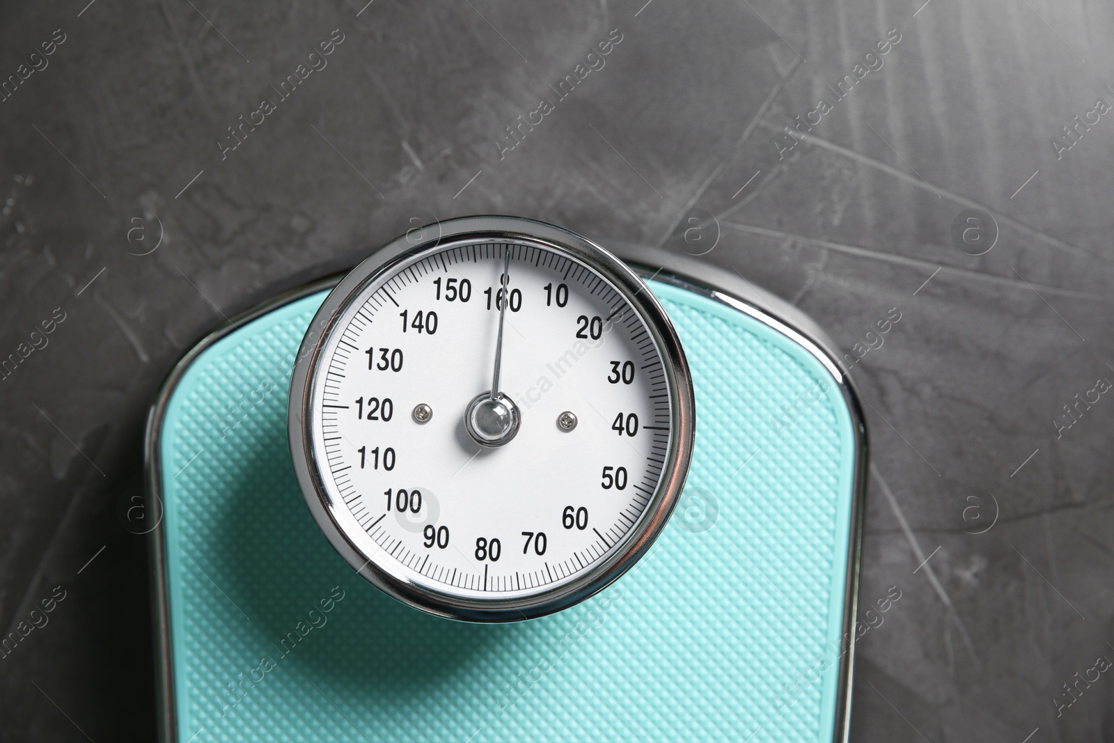 Photo of One bathroom scale on grey textured background, top view