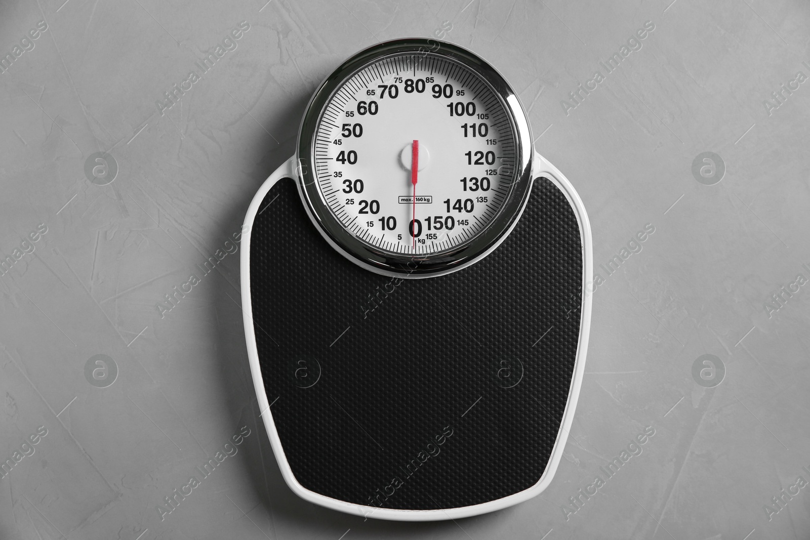 Photo of One bathroom scale on grey textured background, top view