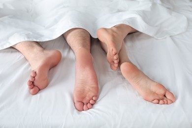 Photo of Lovely couple lying in bed at home, closeup view