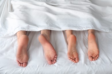 Photo of Lovely couple lying in bed at home, closeup view