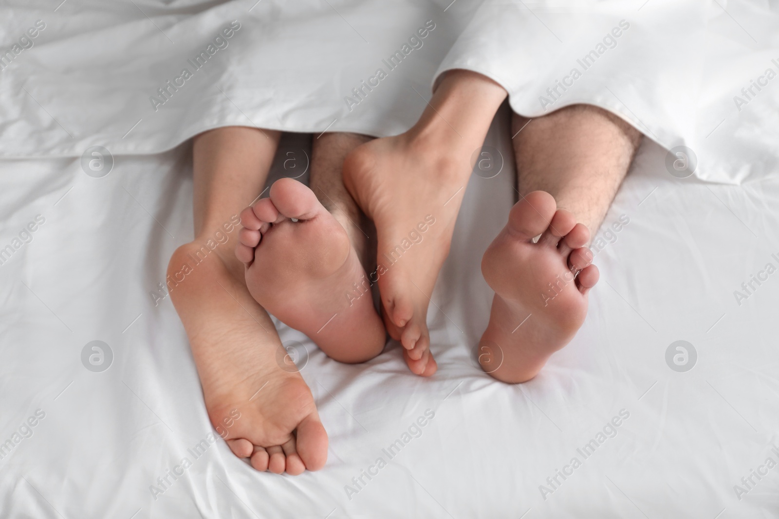 Photo of Lovely couple lying in bed at home, closeup view