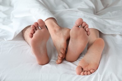 Photo of Lovely couple lying in bed at home, closeup view