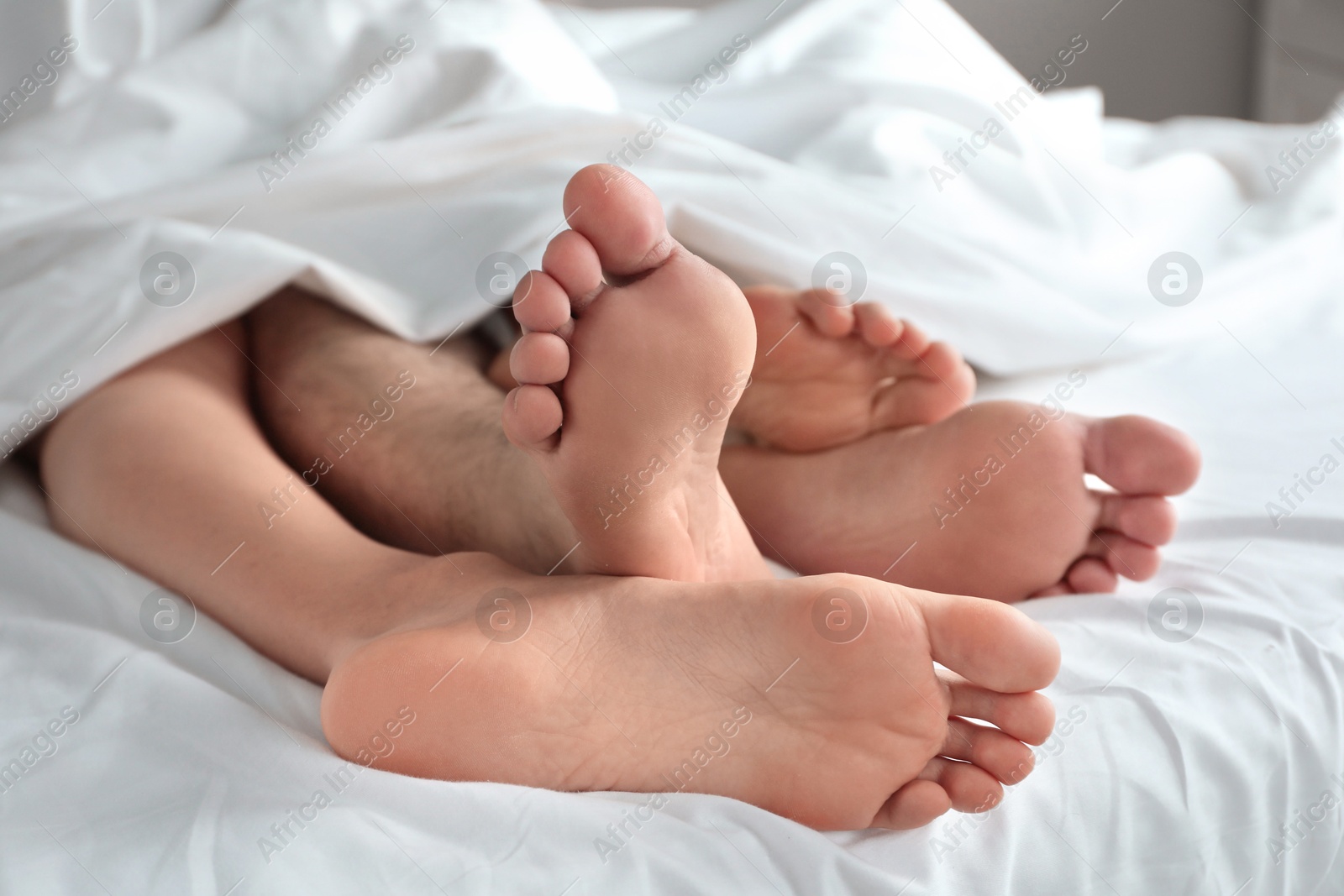 Photo of Lovely couple lying in bed at home, closeup view