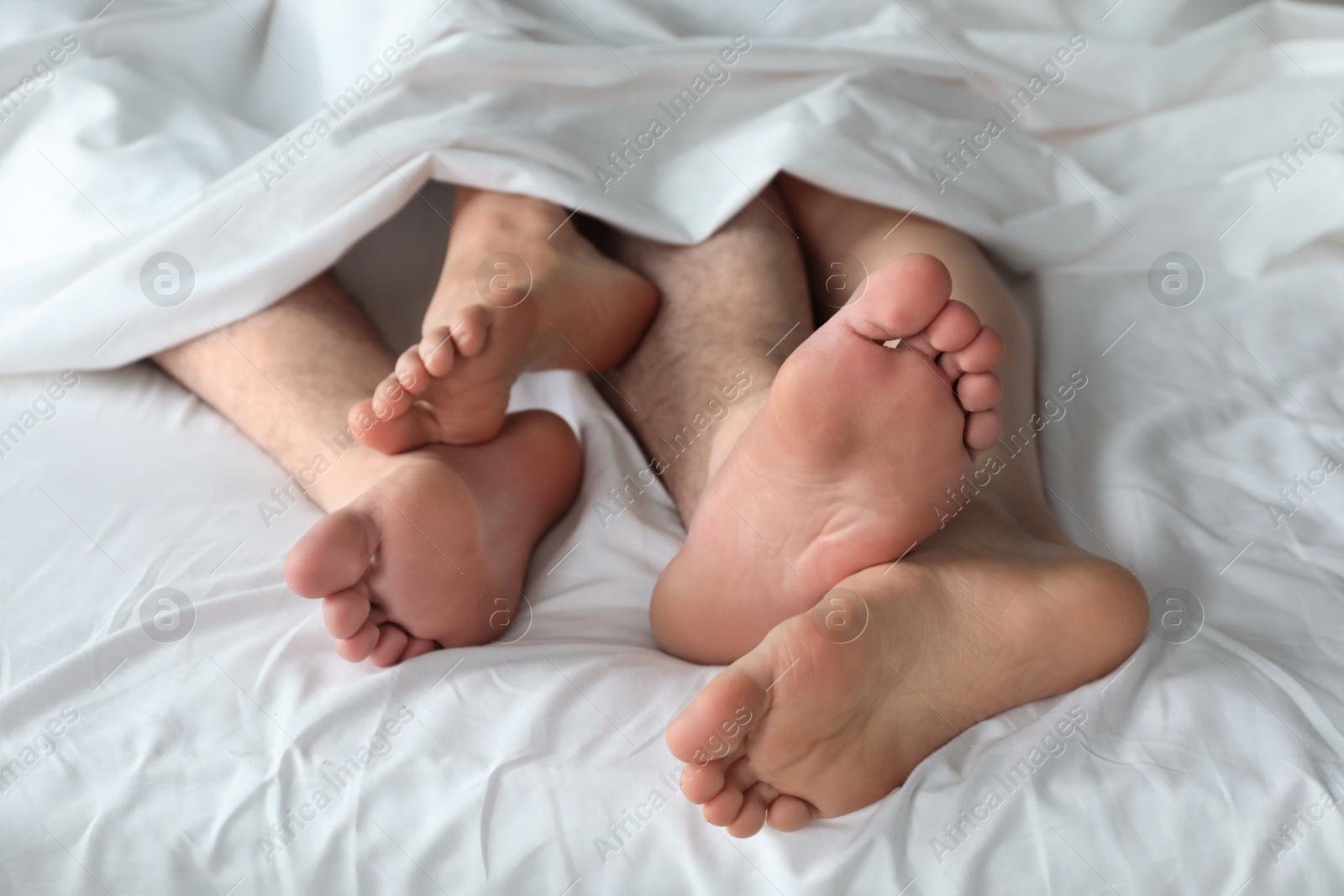 Photo of Lovely couple lying in bed at home, closeup view