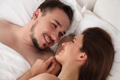Photo of Lovely couple enjoying time together in bed at morning, closeup