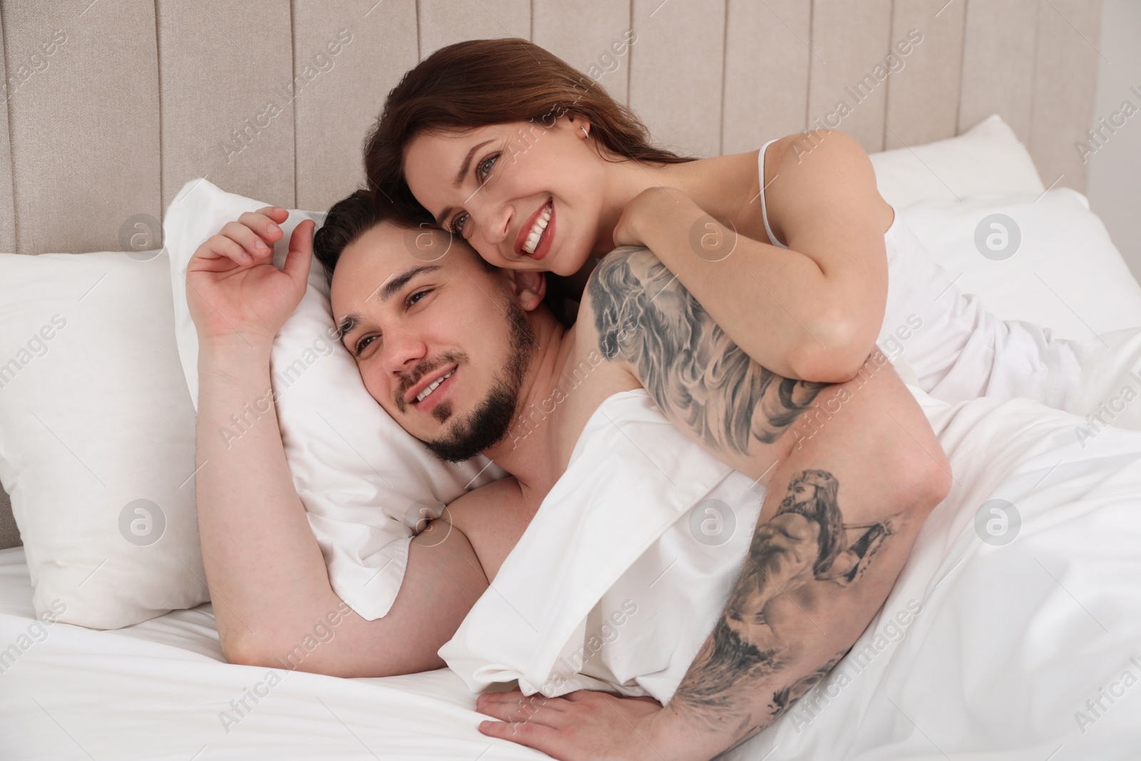 Photo of Lovely couple enjoying time together in bed at morning