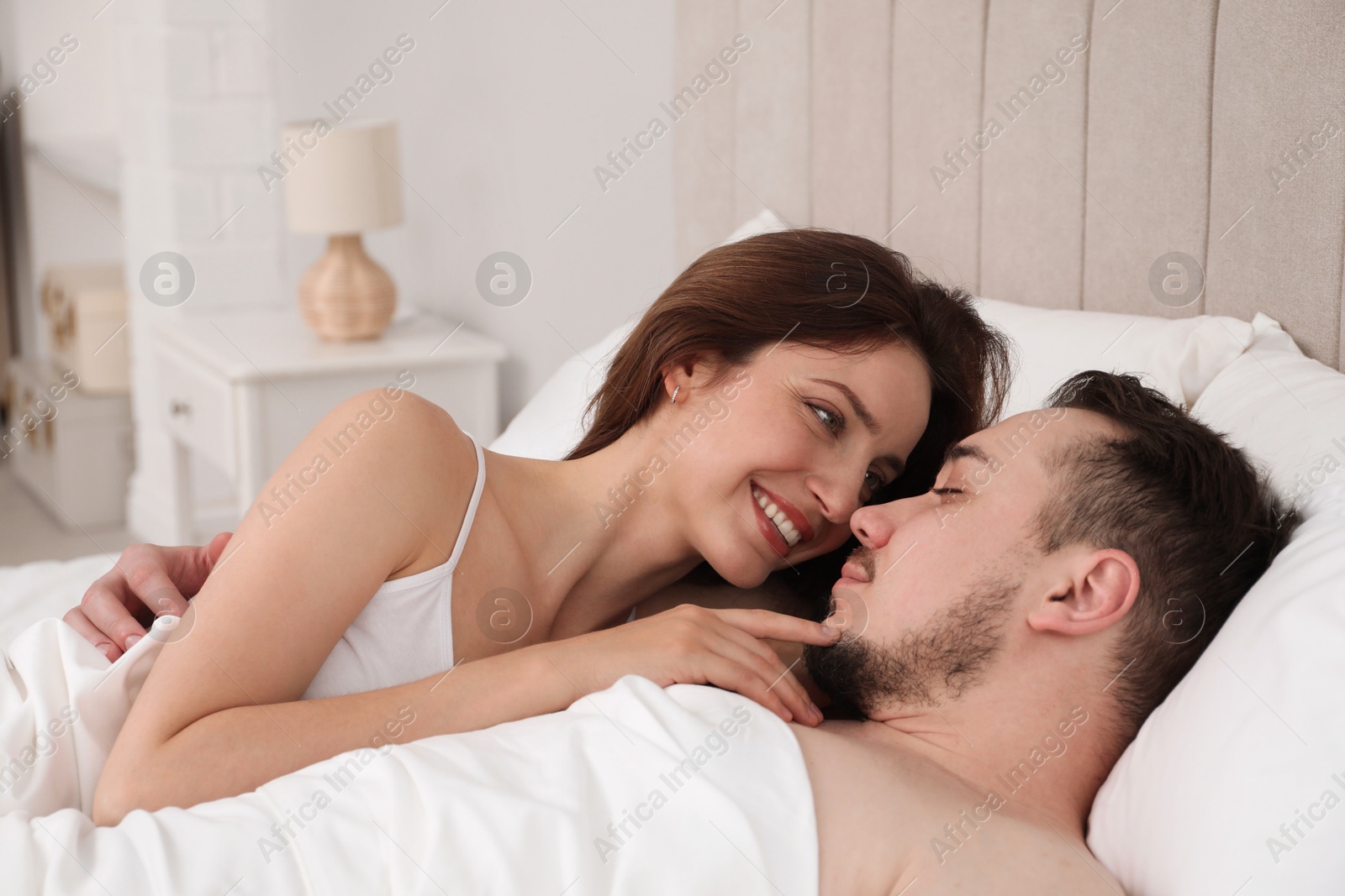 Photo of Lovely couple enjoying time together in bed at morning