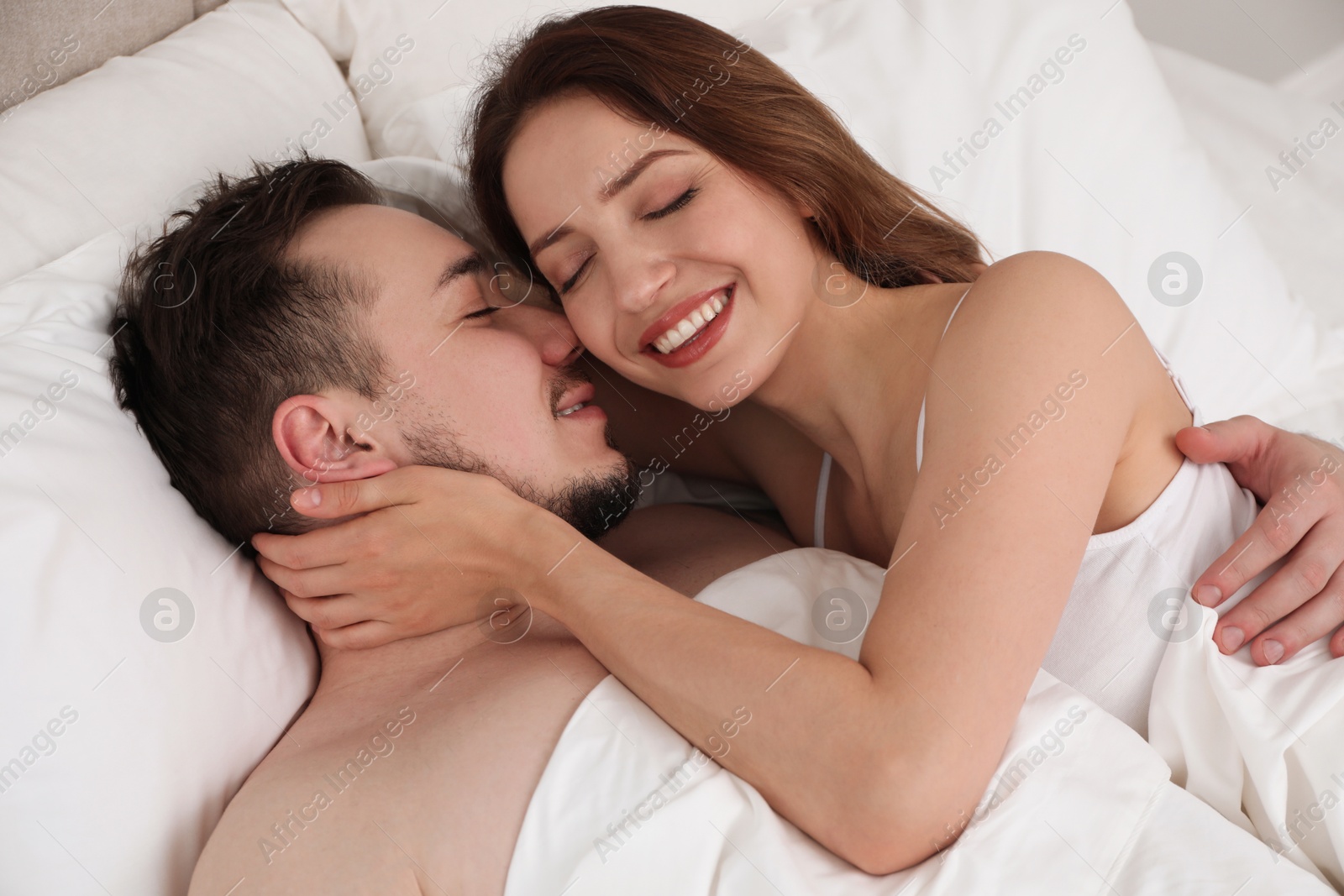 Photo of Lovely couple enjoying time together in bed at morning