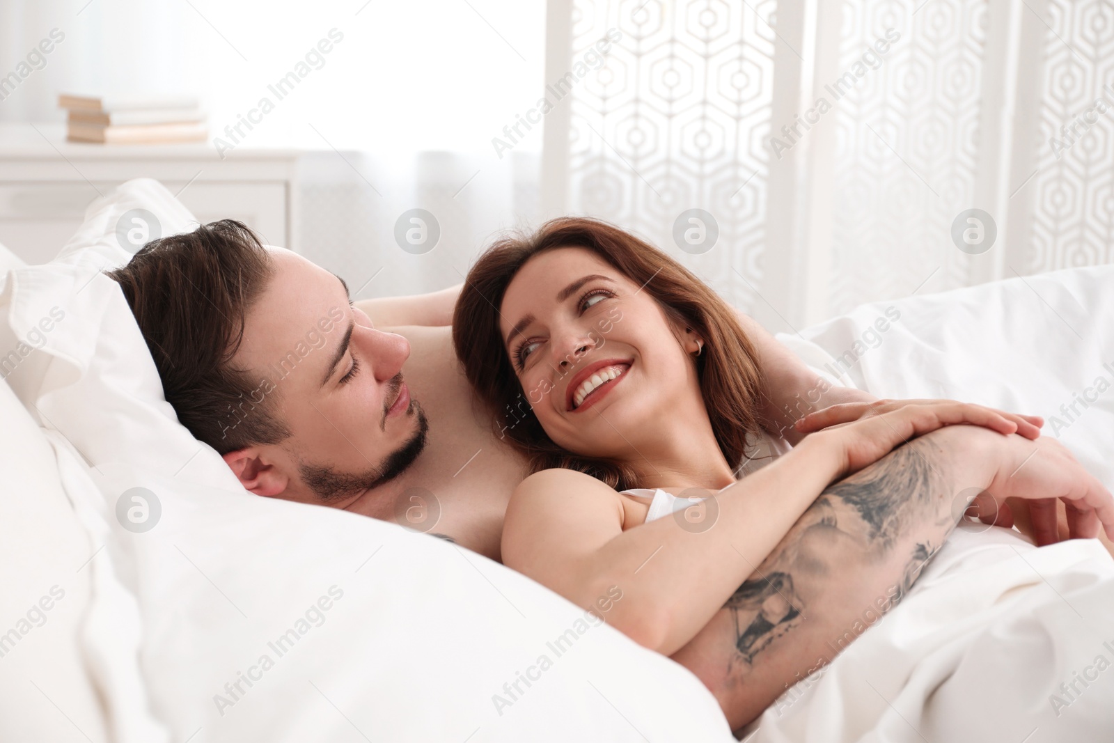 Photo of Lovely couple enjoying time together in bed at morning