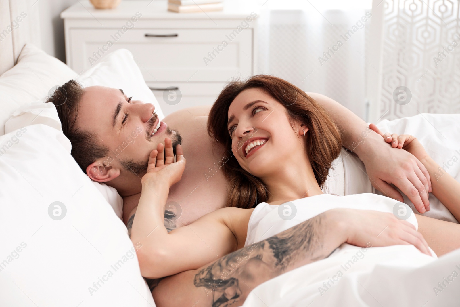 Photo of Lovely couple enjoying time together in bed at morning