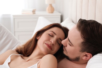 Photo of Lovely couple enjoying time together in bed at morning