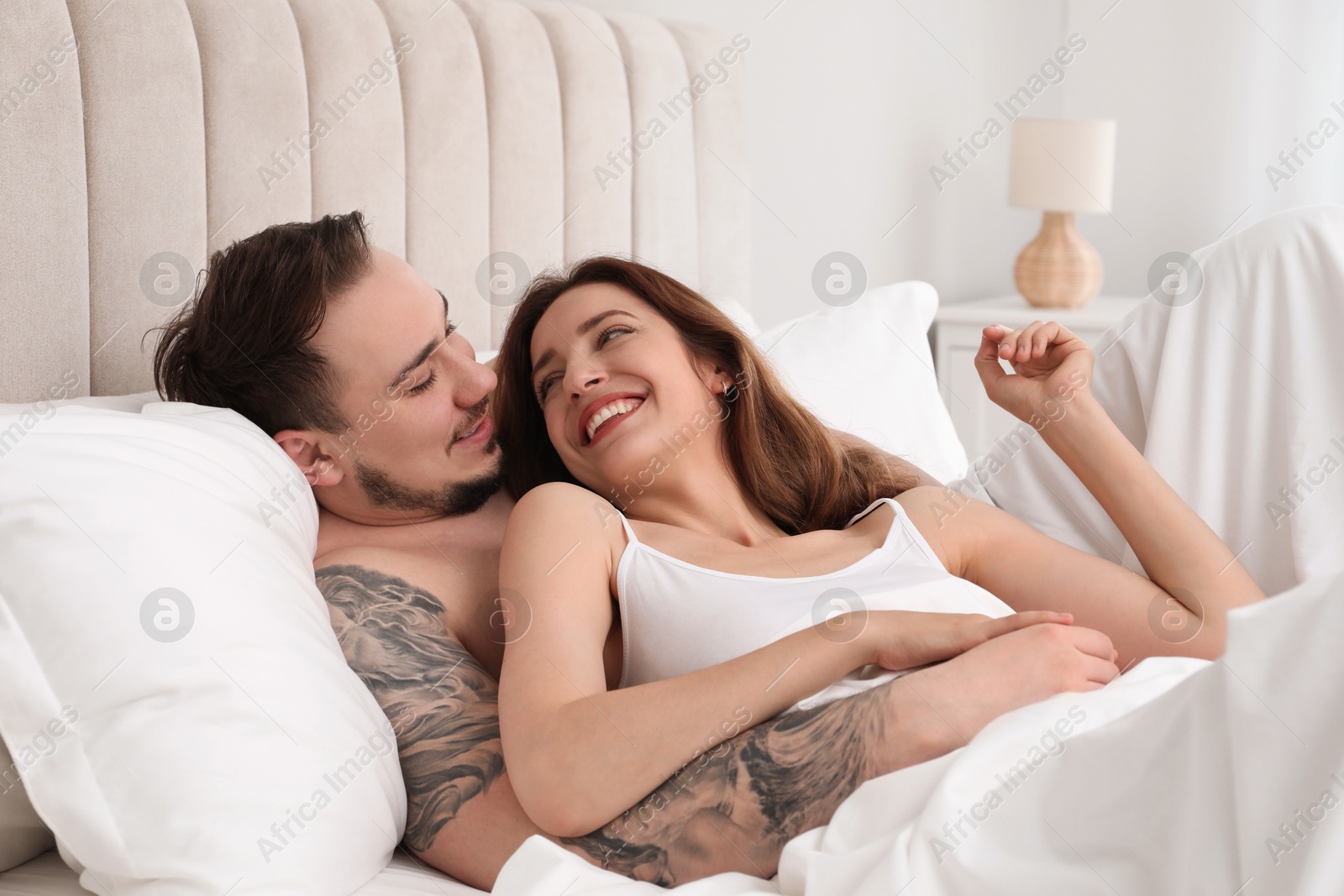 Photo of Lovely couple enjoying time together in bed at morning