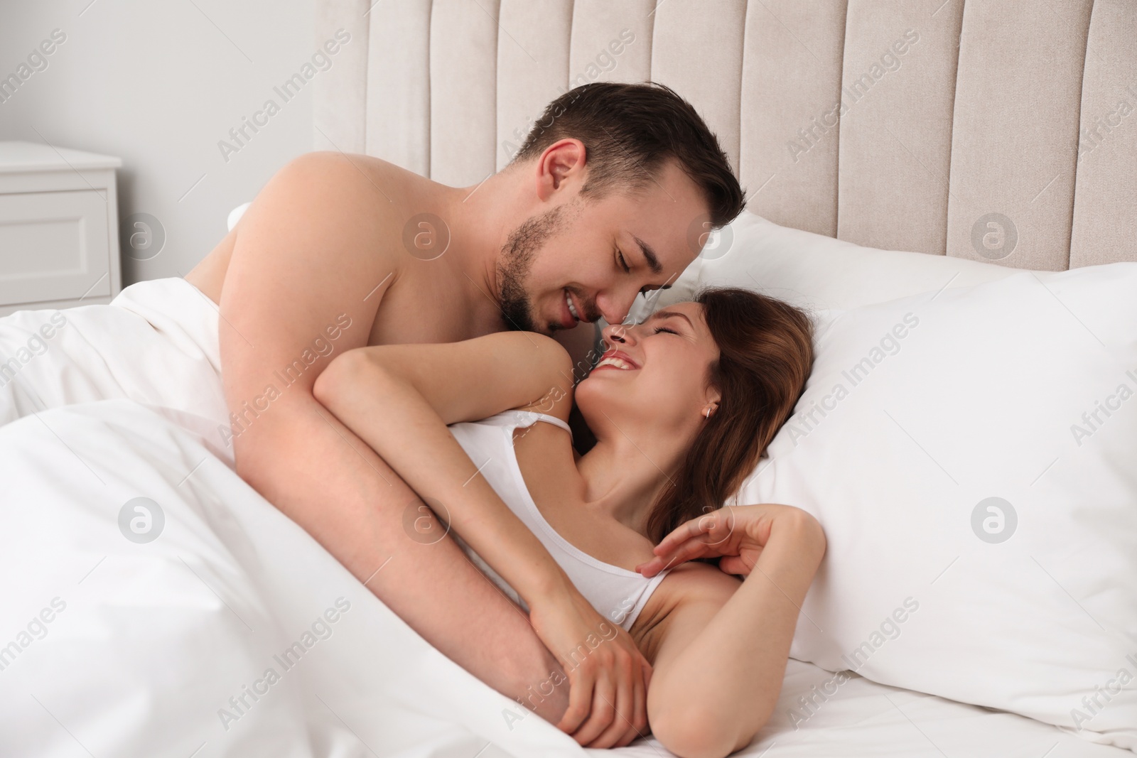 Photo of Lovely couple enjoying time together in bed at morning