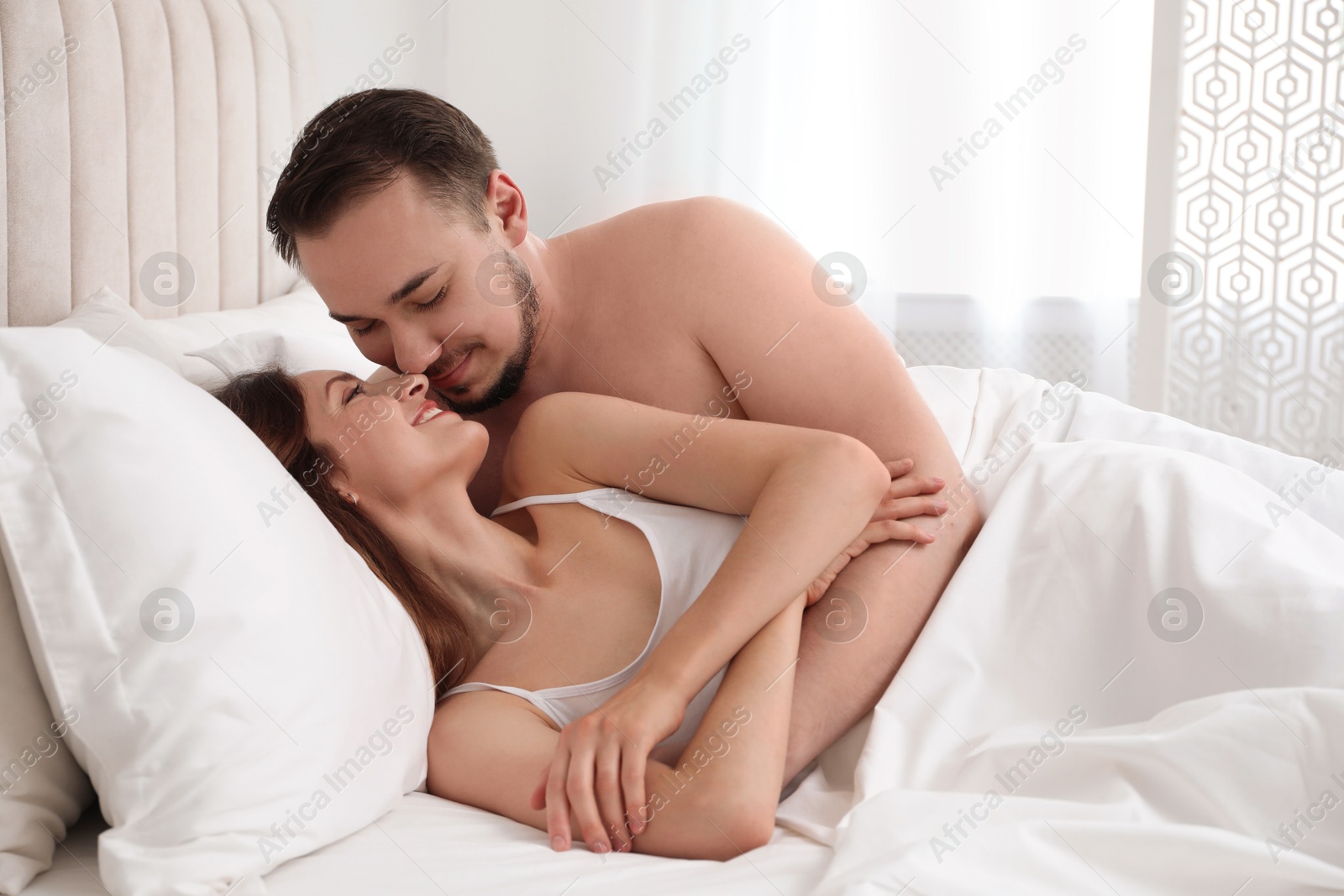 Photo of Lovely couple enjoying time together in bed at morning