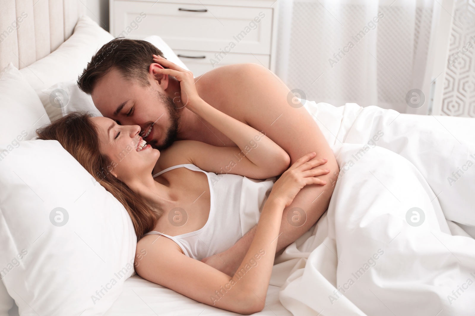 Photo of Lovely couple enjoying time together in bed at morning