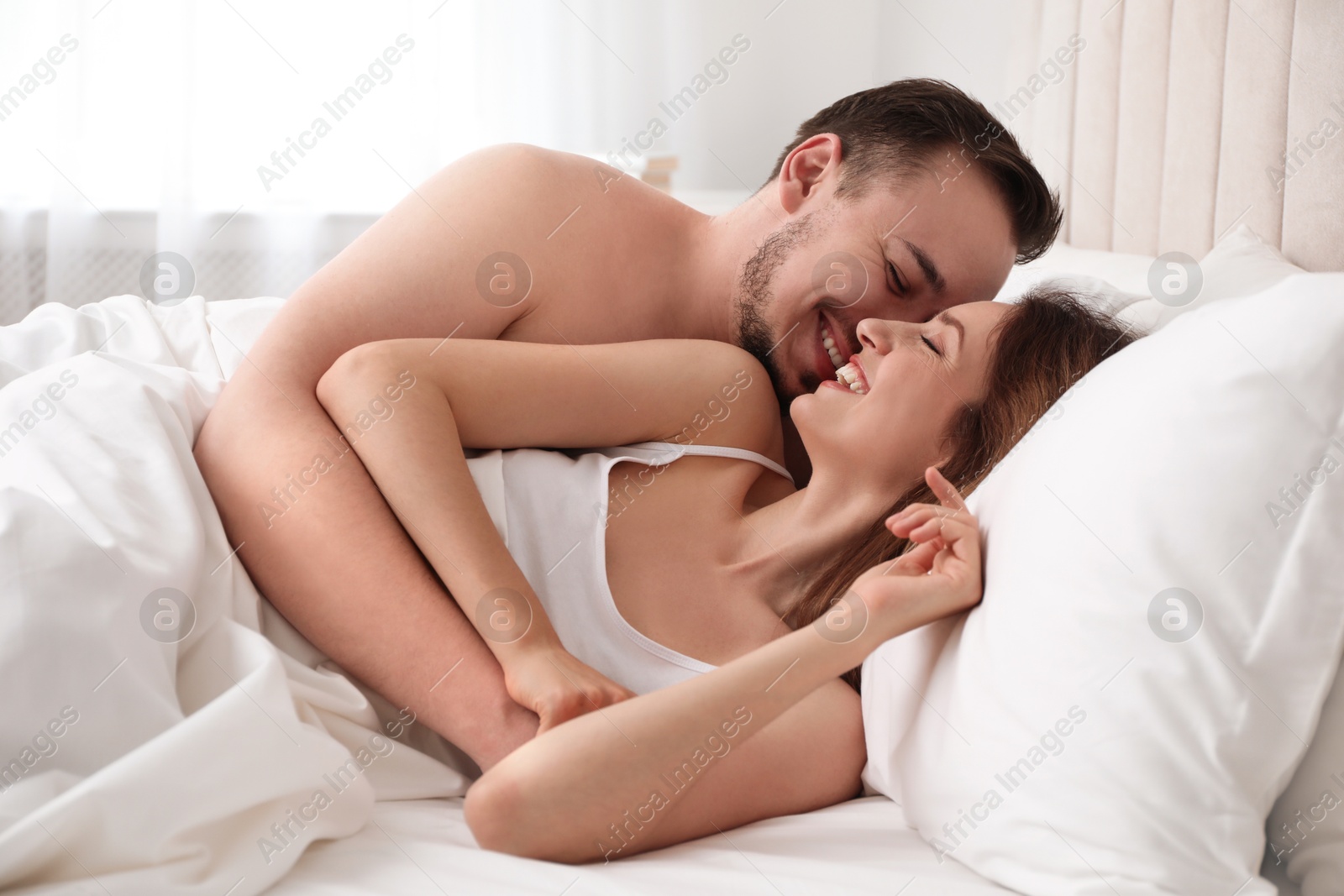 Photo of Lovely couple enjoying time together in bed at morning