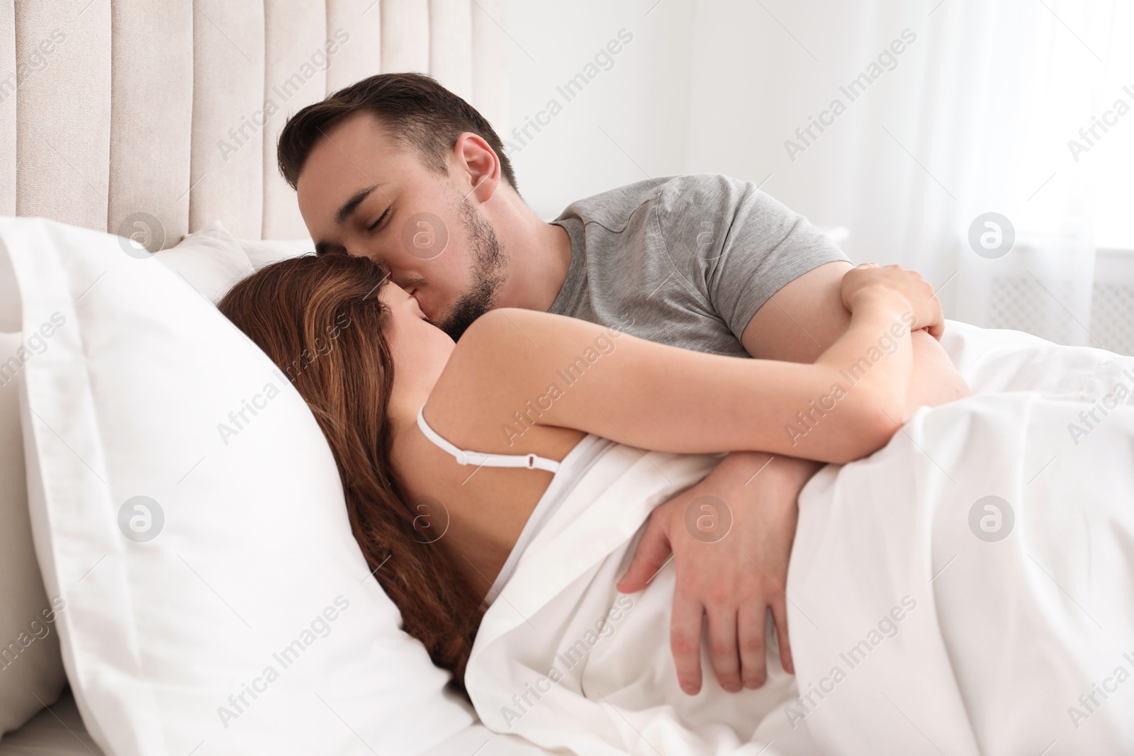 Photo of Lovely couple enjoying time together in bed at morning