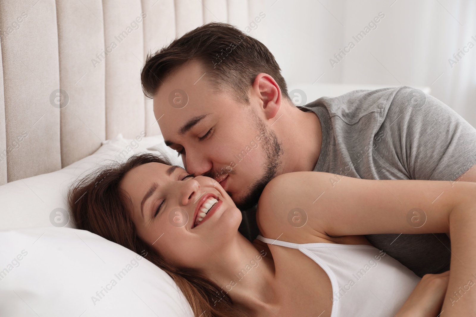 Photo of Lovely couple enjoying time together in bed at morning