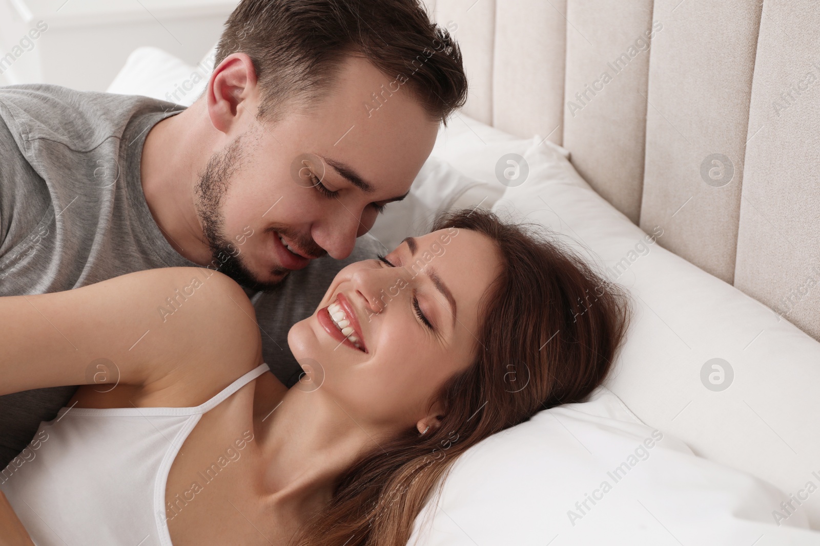 Photo of Lovely couple enjoying time together in bed at morning