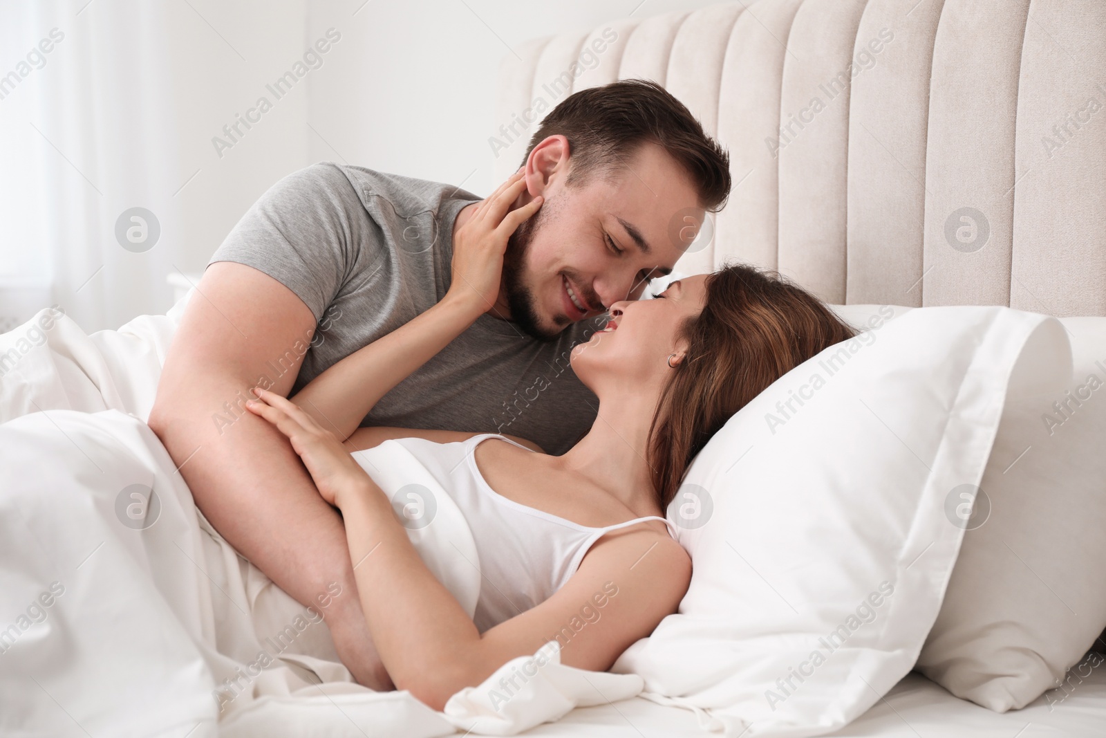 Photo of Lovely couple enjoying time together in bed at morning