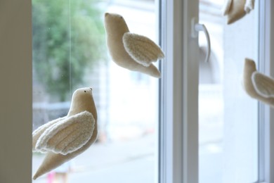 Photo of Beautiful handmade toy birds hanging near window