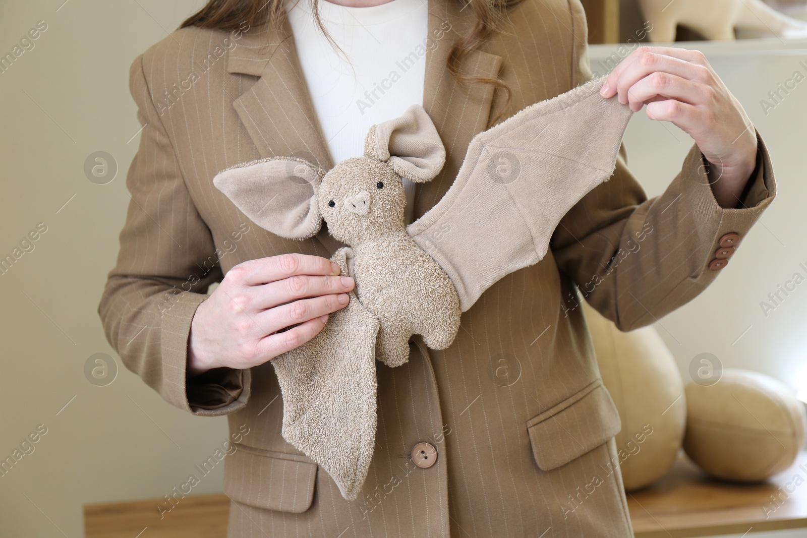 Photo of Woman with cute handmade bat in workshop, closeup