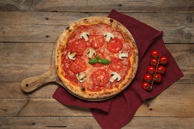 Photo of Delicious pizza with tomatoes, mushrooms and basil on wooden table, flat lay