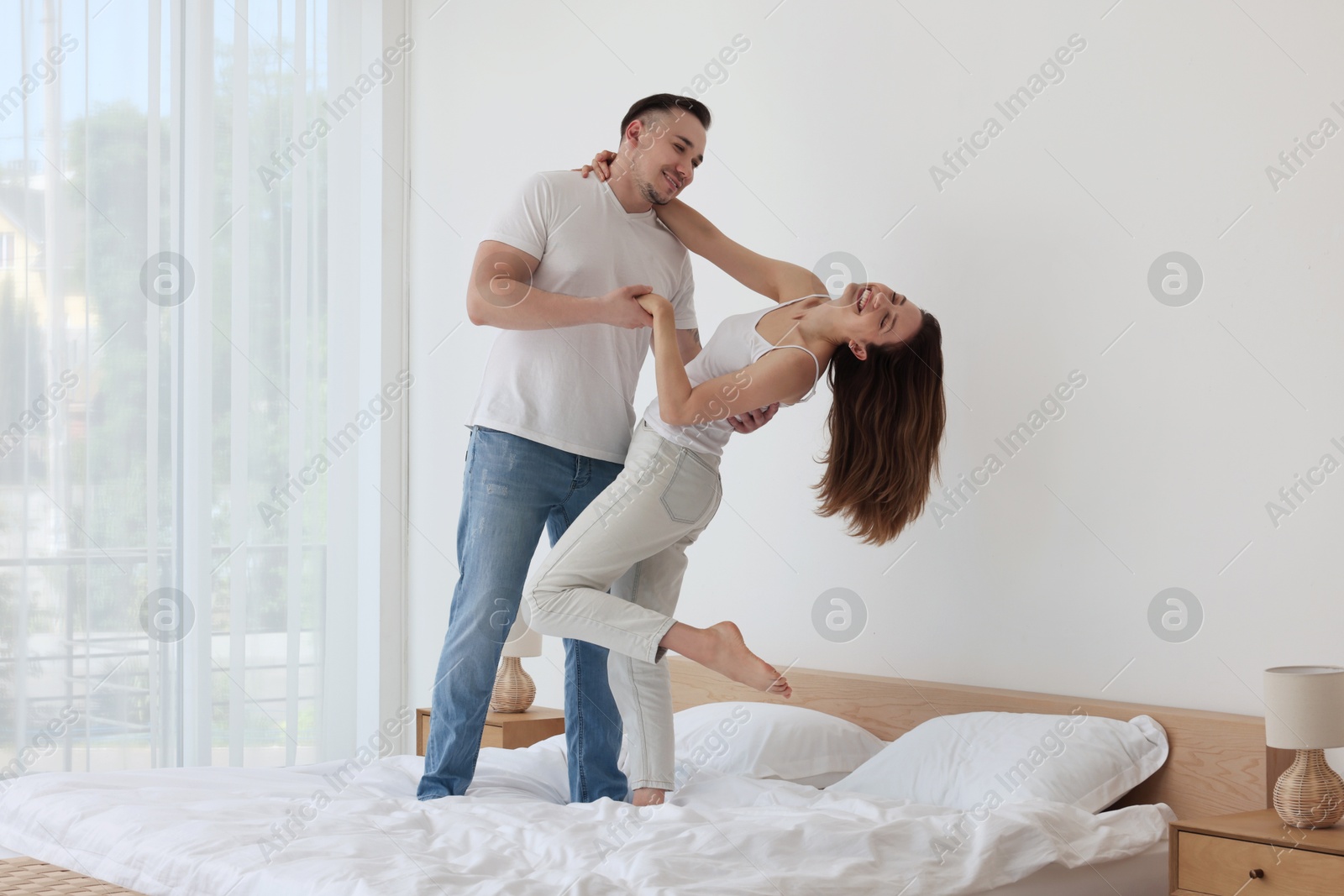 Photo of Lovely couple spending time together on bed at home